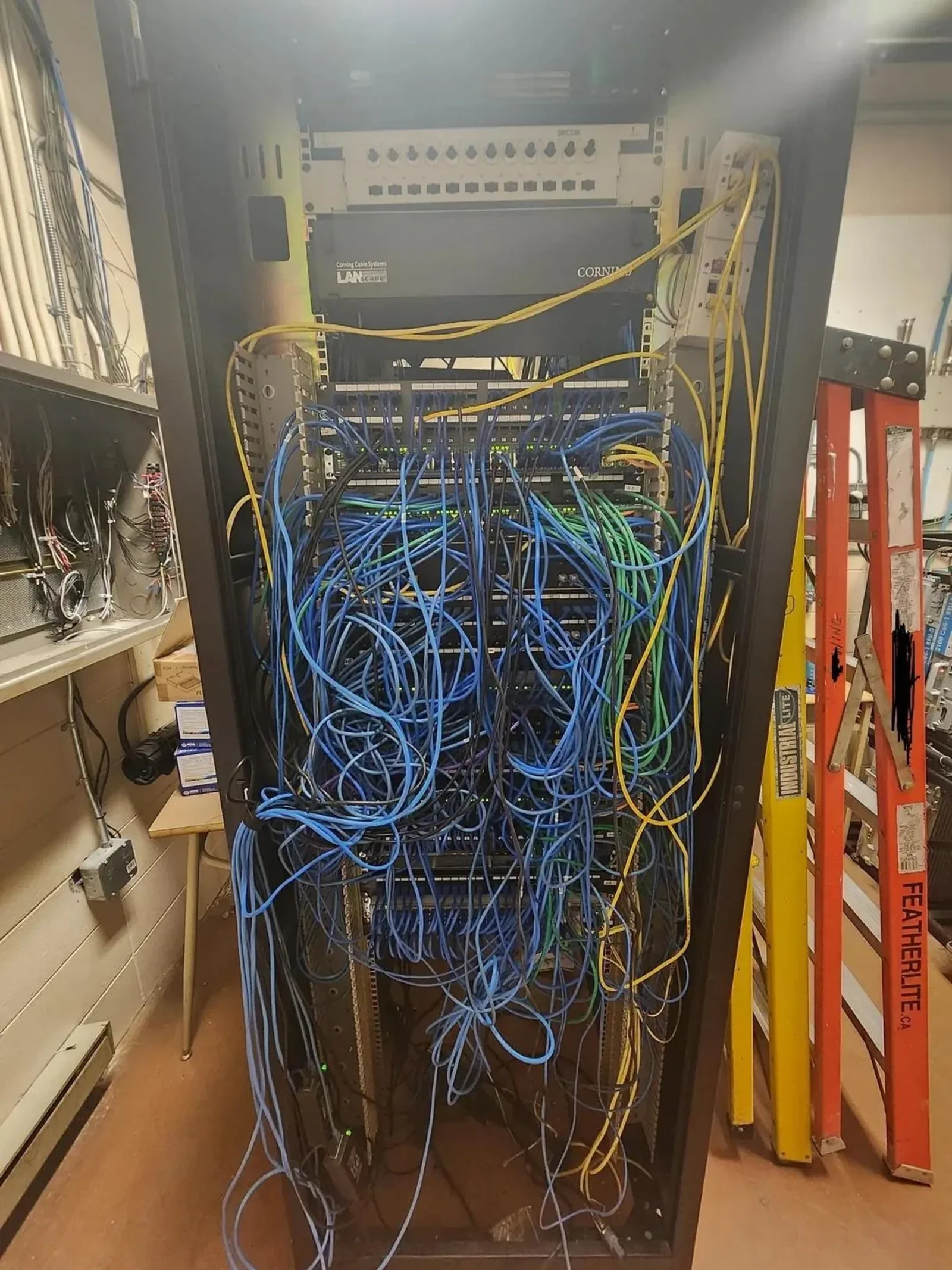 Middle room before cleanup — tangle of unlabeled cables